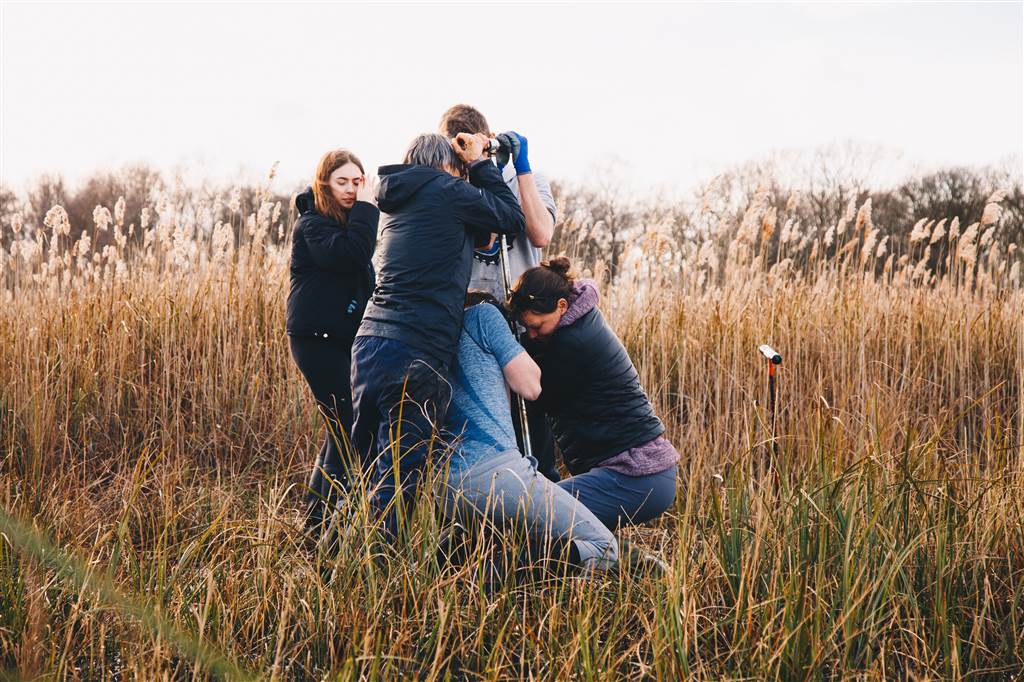 A group of people taking a peat core